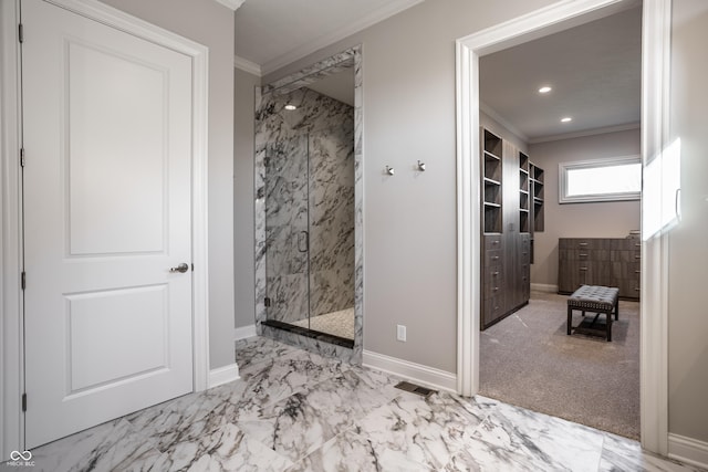 bathroom with a shower with shower door and crown molding