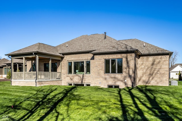 rear view of property featuring a yard