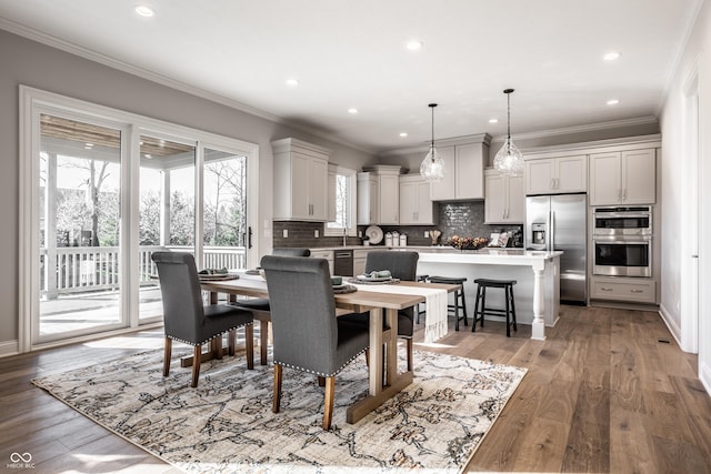 dining space featuring wood-type flooring and ornamental molding