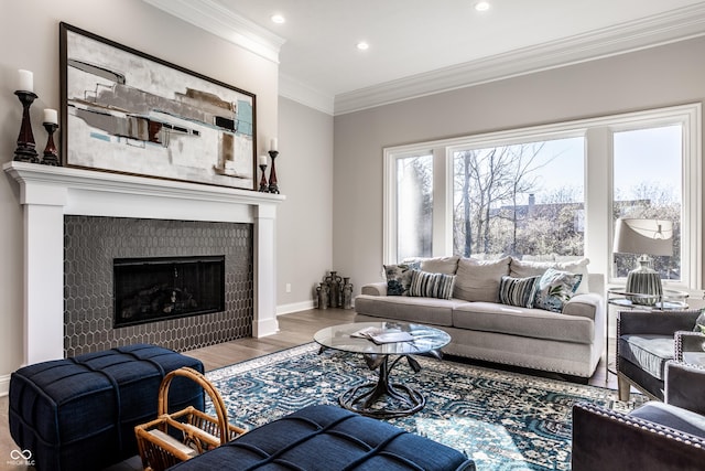 living room featuring a tile fireplace, hardwood / wood-style flooring, and ornamental molding