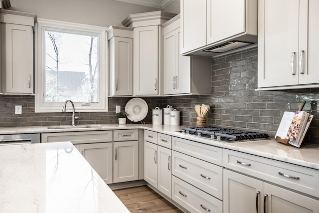 kitchen featuring light stone countertops, appliances with stainless steel finishes, tasteful backsplash, and sink