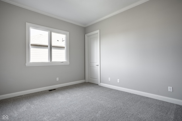 carpeted spare room featuring crown molding