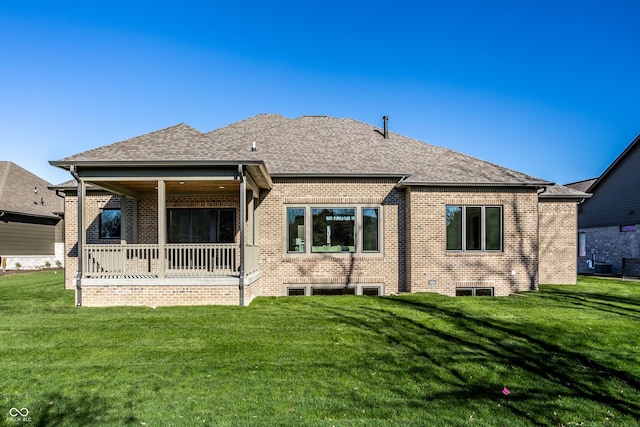 back of house featuring a lawn, central AC unit, and covered porch