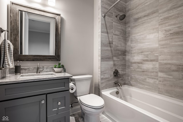 full bathroom with tiled shower / bath, vanity, and toilet