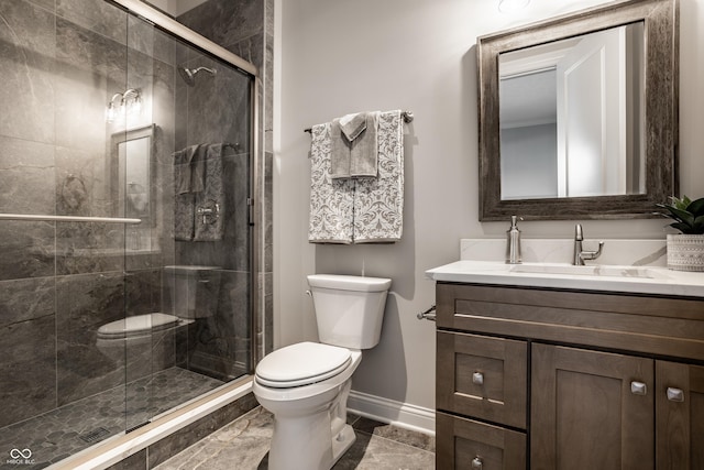 bathroom featuring vanity, toilet, and a shower with door