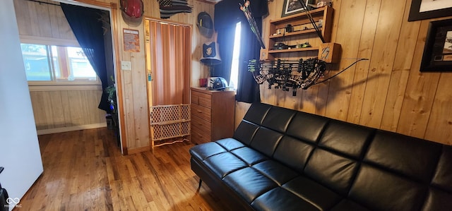 living room featuring wood-type flooring and wood walls