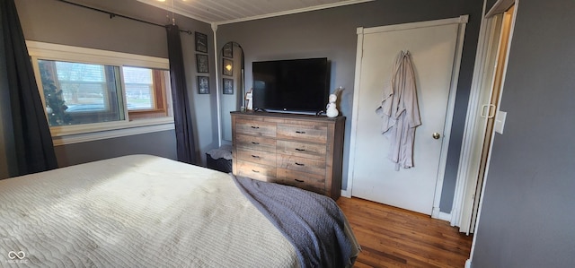 bedroom featuring dark wood-type flooring and ornamental molding