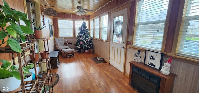 sunroom / solarium featuring ceiling fan and wooden ceiling