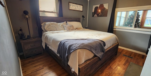 bedroom with dark hardwood / wood-style flooring