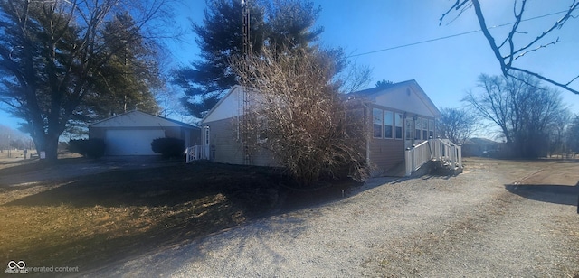 view of side of home featuring a garage and an outdoor structure