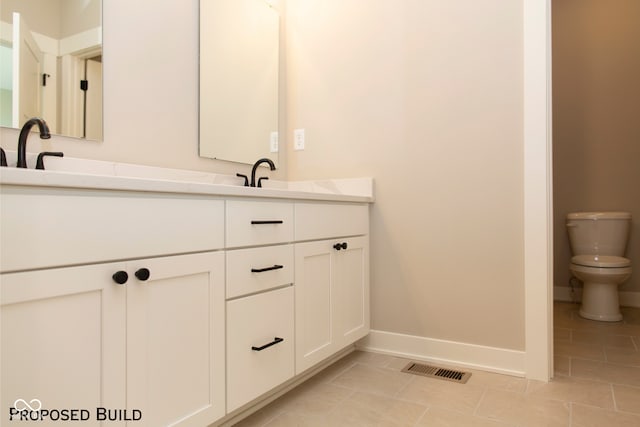 bathroom with tile patterned floors, vanity, and toilet