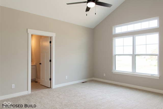 carpeted spare room featuring ceiling fan and lofted ceiling