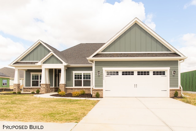 craftsman-style house featuring a front yard and a garage