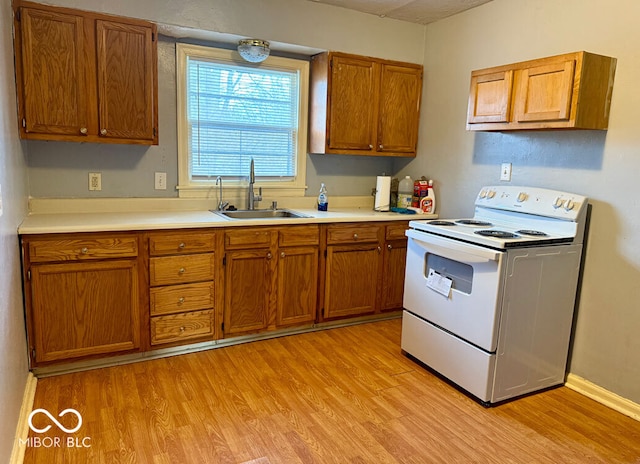 kitchen with sink, light wood-type flooring, and white electric stove