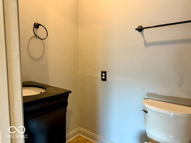 bathroom with tile patterned flooring, vanity, and toilet