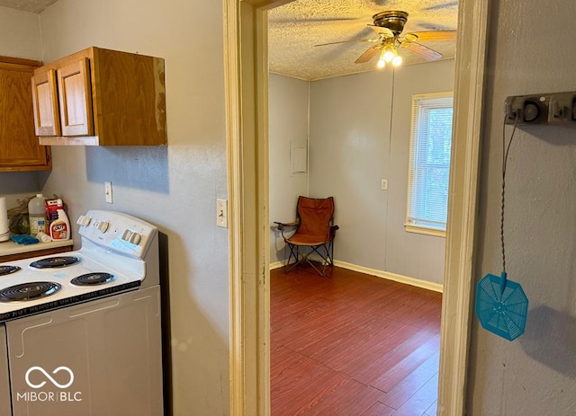 kitchen featuring ceiling fan, dark hardwood / wood-style flooring, white electric range, and a textured ceiling