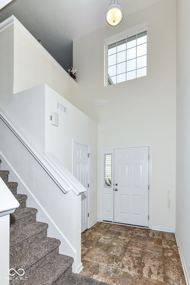 entryway featuring a towering ceiling