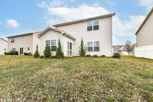 rear view of house with a yard