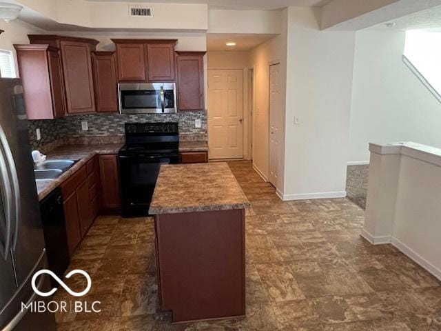 kitchen with black appliances, backsplash, a center island, and sink