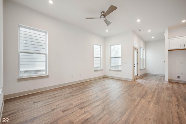 unfurnished living room with ceiling fan and light hardwood / wood-style flooring