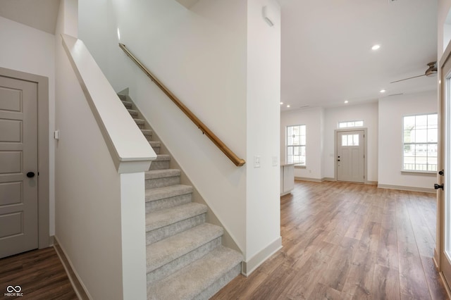 stairway with hardwood / wood-style floors