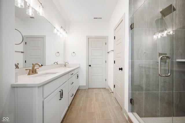 bathroom featuring vanity and a shower with shower door