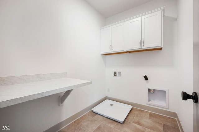 clothes washing area with electric dryer hookup, cabinets, light tile patterned floors, and hookup for a washing machine