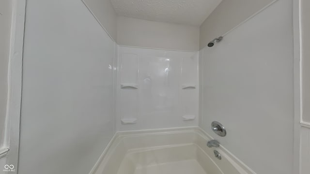 bathroom featuring shower / tub combination and a textured ceiling