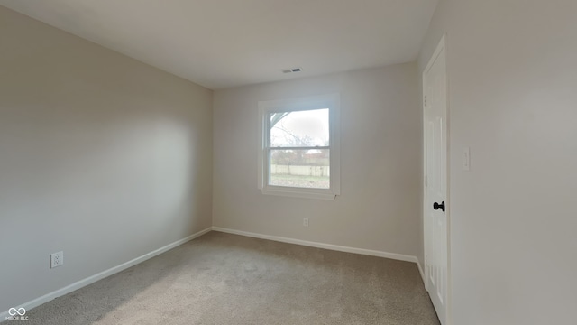 unfurnished room featuring light colored carpet