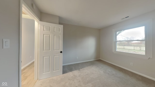 spare room with light colored carpet