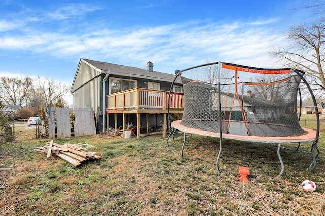 view of playground featuring a deck and a trampoline