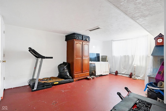 exercise area featuring a textured ceiling