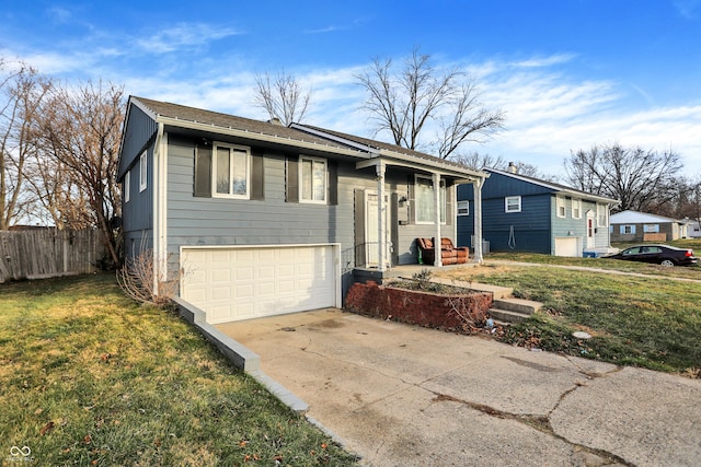 bi-level home with a front yard and a garage