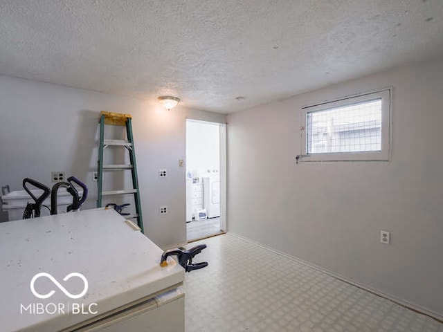 interior space with a textured ceiling and washer / clothes dryer