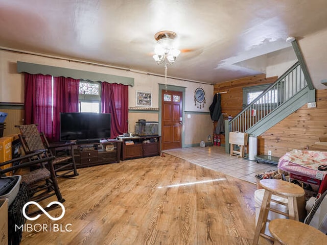 living room with hardwood / wood-style floors and wood walls