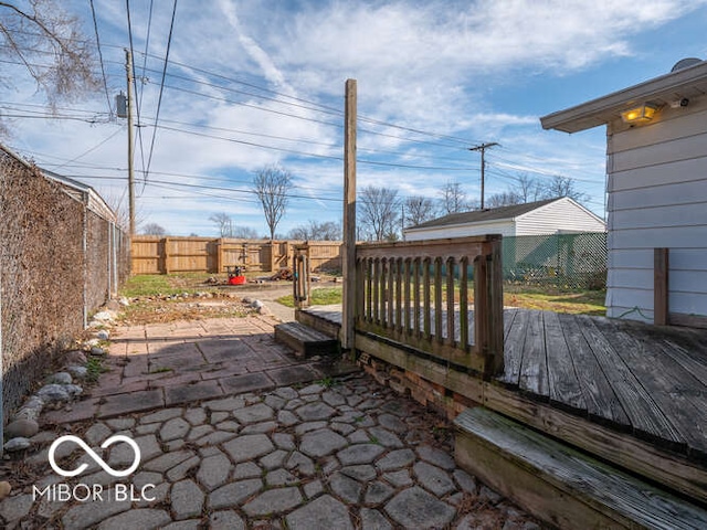 wooden terrace with a patio area