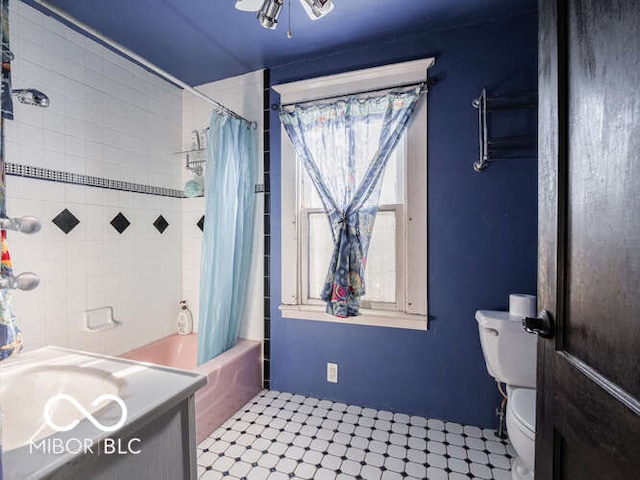 bathroom with tile patterned flooring, toilet, and shower / bath combo with shower curtain