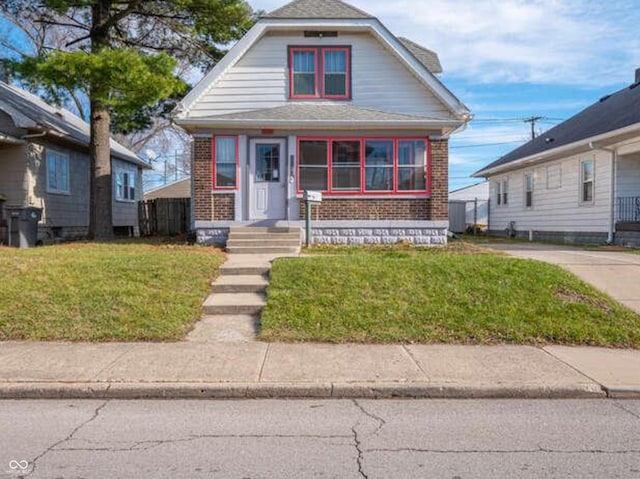 bungalow-style home with a front lawn