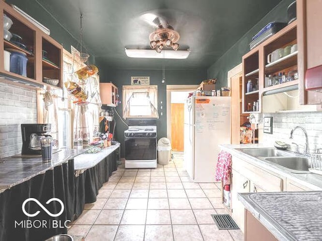 kitchen featuring decorative backsplash, sink, light tile patterned floors, and white appliances