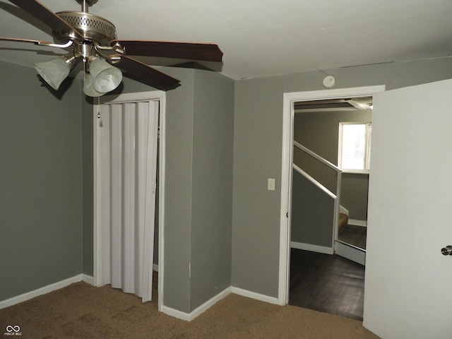 interior space featuring ceiling fan, dark hardwood / wood-style flooring, baseboard heating, and a closet