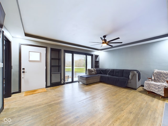 living room featuring light hardwood / wood-style flooring and ceiling fan