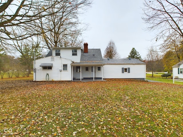 back of house with a patio area and a yard