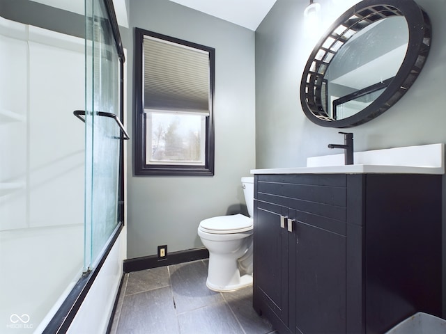 full bathroom featuring vanity, toilet, and bath / shower combo with glass door