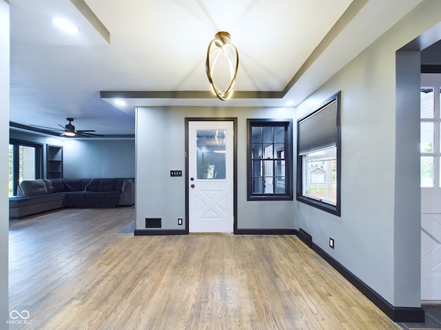 foyer with hardwood / wood-style floors and ceiling fan