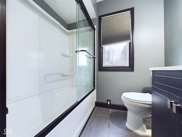 full bathroom featuring tile patterned flooring, vanity, toilet, and shower / bath combination with glass door