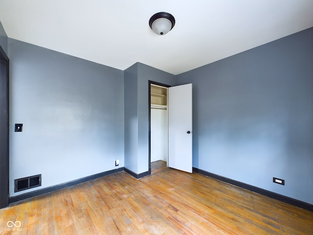 unfurnished room with hardwood / wood-style floors