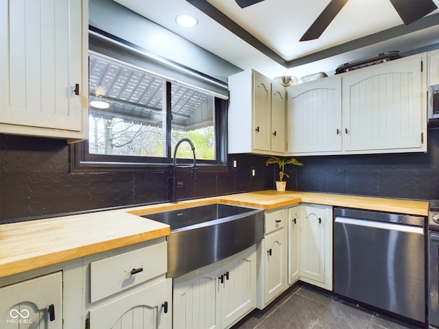 kitchen with dishwasher, wooden counters, and sink