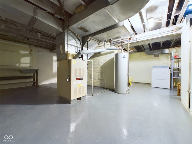 basement featuring washer / clothes dryer, water heater, and heating unit