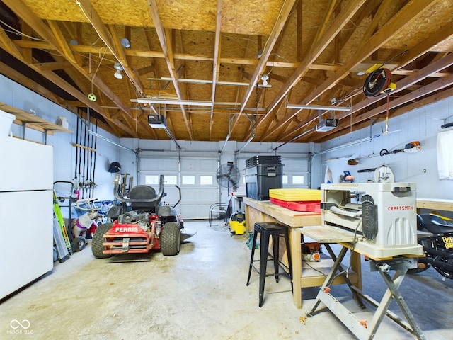 garage featuring white fridge and a garage door opener