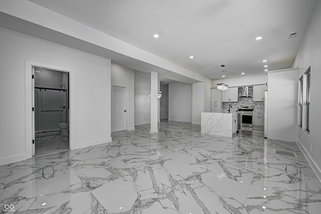 unfurnished living room featuring sink